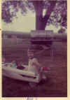Me drivng the pedal boat around the yard.